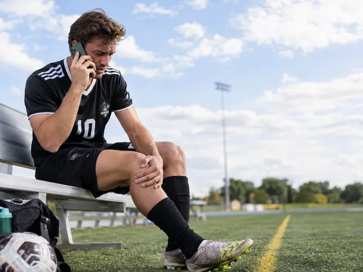 Athlete calling for urgent physical therapy appointment for sports injury