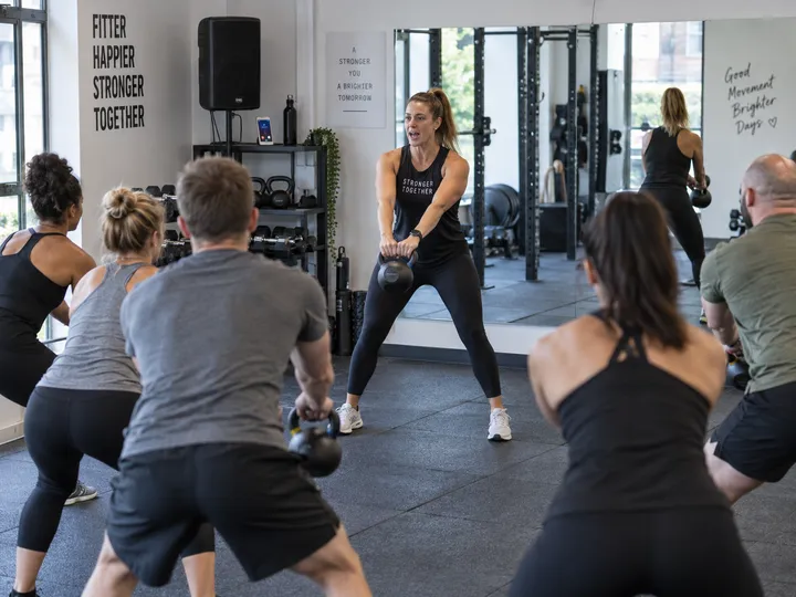 Fitness instructor mid-class while AI handles incoming call