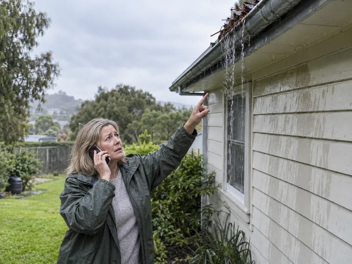 Homeowner urgently calling about overflowing blocked gutters