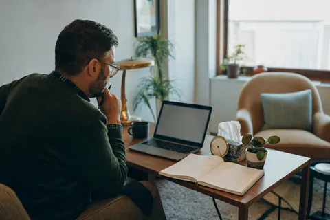 A therapist checking their schedule on a laptop between client sessions.