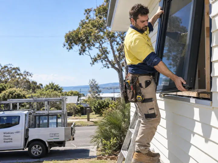 Window installer on ladder unable to answer phone while fitting aluminium windows